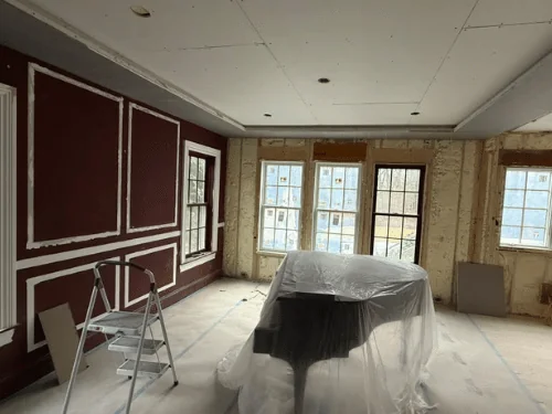 New drywall ceiling with a perimeter soffit over a red room with patched panel outlines