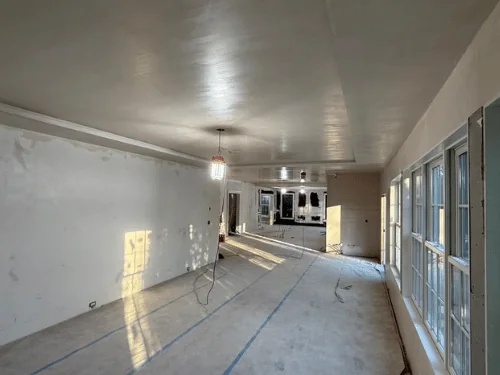 Long room after taping and finishing, drywall walls and soffit ready for paint