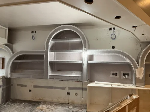 Arched shelf niches framed in board with metal corner bead, before the finish coat