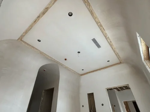 Coved plaster ceiling with curved corners rising from the walls to a flat center panel