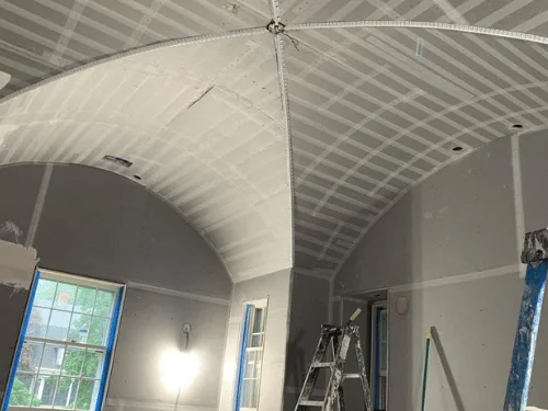 Groin-vaulted ceiling with every blueboard joint taped and coated, ready for the finish coat