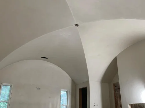 Finished groin-vaulted ceiling and arched openings in smooth plaster