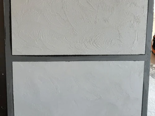 Two panels of hand-troweled textured plaster framed by a gray border