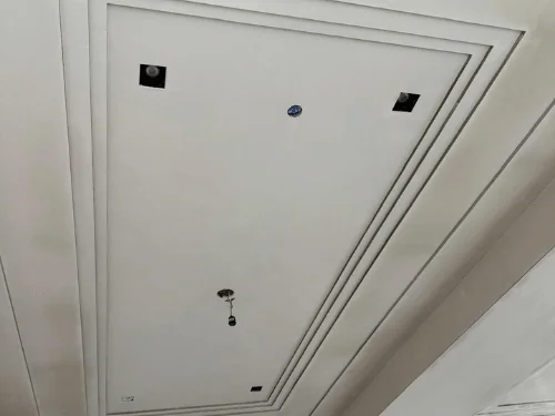 Stepped tray ceiling with three recessed tiers, finished in white plaster
