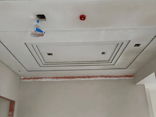 White plaster ceiling with a stepped tray outline and a recessed perimeter reveal